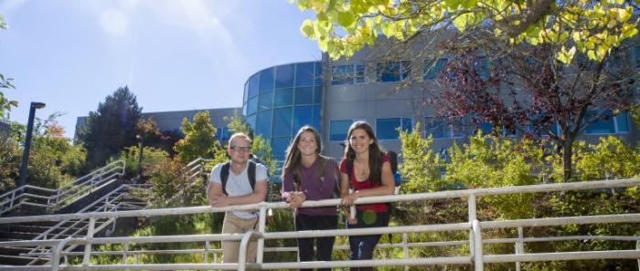 Three VIU students spending time outside building 200 on a warm sunny day.